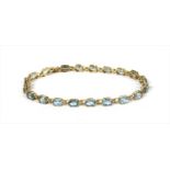 A gold aquamarine line bracelet,