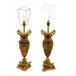 A pair of bronze urn form table lamps having gilt mounts, (2)