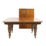 A Victorian oak extending dining table,