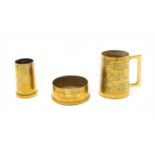 Two brass shell case items and mug