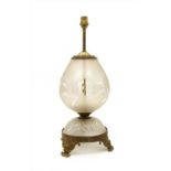 An etched glass and gilt metals table lamp