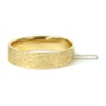 A 9ct gold hollow hinged bangle,