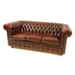 A red leather Chesterfield three seater sofa,