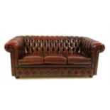 A red leather Chesterfield three seater sofa,