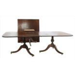 A Georgian style triple pillar mahogany dining table,