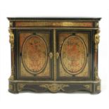 A red boulle and ebonised cabinet,