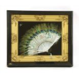 A peacock feather and bone fan,