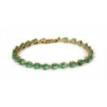 A silver gilt emerald line bracelet,