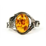 A sterling silver hinged amber bangle,