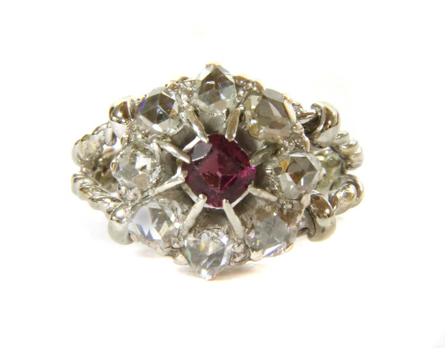 An Edwardian garnet and diamond circular cluster