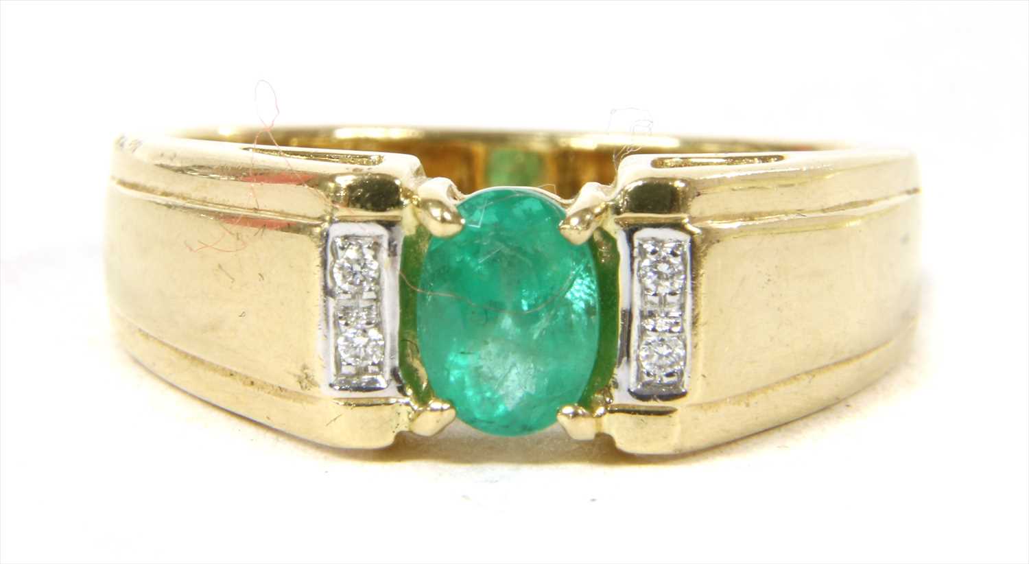 An 18ct gold emerald and diamond ring,