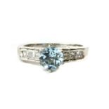 A platinum blue topaz and diamond ring