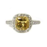 A platinum citrine and diamond halo cluster ring