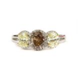 An 18ct white gold three stone fancy diamond and white diamond regal cluster ring