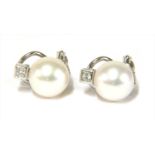 A pair of white gold cultured pearl and diamond earrings,
