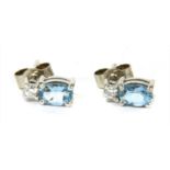 A pair of 18ct white gold aquamarine and diamond earrings,