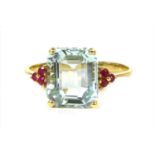 A gold aquamarine and ruby ring,