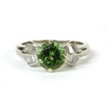 A platinum peridot and diamond ring