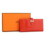 An Hermès red alligator skin wallet