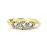 A gold three stone diamond ring,