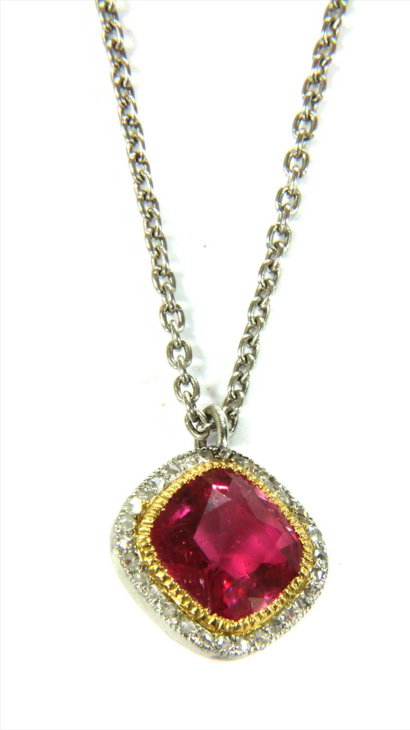 A platinum pink tourmaline and diamond halo cluster pendant