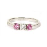 An 18ct white gold three stone diamond and pink sapphire ring,