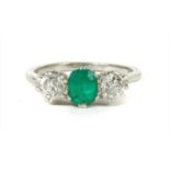 A three stone emerald and diamond ring,