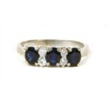 A white gold seven stone sapphire and diamond ring,