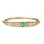 A late Victorian emerald and diamond hinged bangle, c.1880