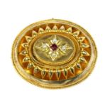 A Victorian Etruscan Revival gold garnet and split pearl brooch