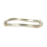 An Italian 18ct white gold wave bangle,