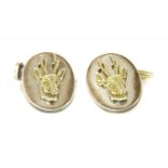 A pair of silver gilt stag cufflinks, by Holland & Holland