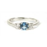 An 18ct white gold three stone aquamarine and diamond ring,