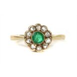 A gold emerald and diamond cluster ring,