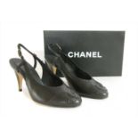 A pair of Chanel sling-back black shoes,