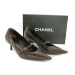 A pair of Chanel chocolate brown leather court shoes,