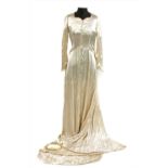 A vintage cream satin wedding dress and head piece