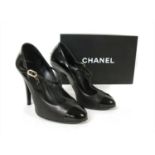 A pair of Chanel back patent leather T-bar shoes