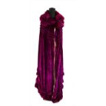 A theatrical fuchsia pink velvet cape