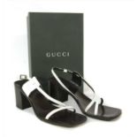 A pair of Gucci block heel strap sandals