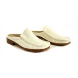 A pair of Bally cream patent leather slip on mules,