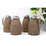Four animal print covered hot water jugs
