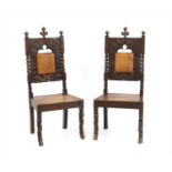 A pair of carved oak standard chairs,