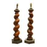 A pair of walnut barley-twist carved column lamps