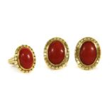 A gold coral ring and earrings suite,