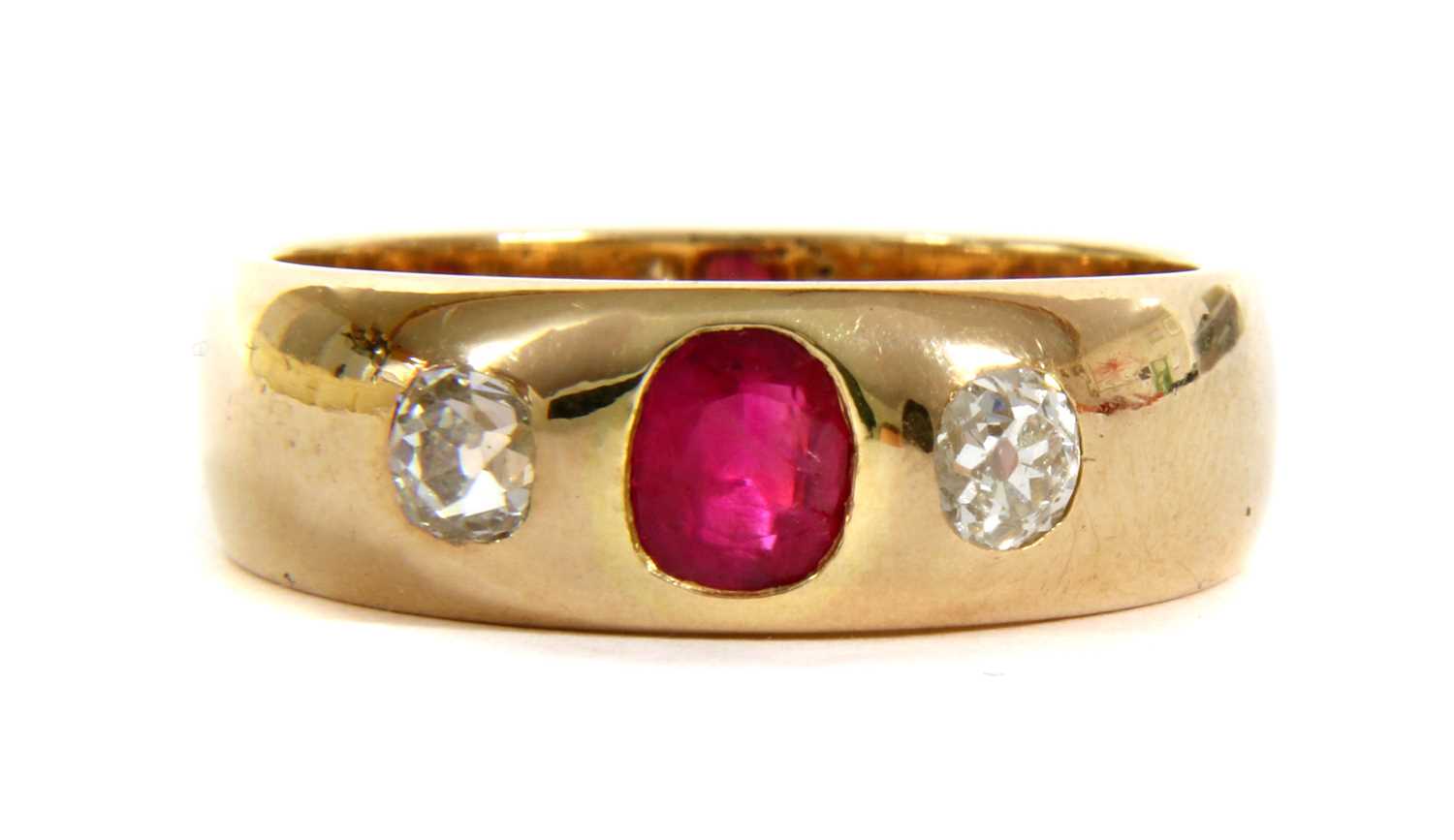 A gold ruby and diamond three stone ring,