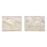 A pair of white classical wall plaques