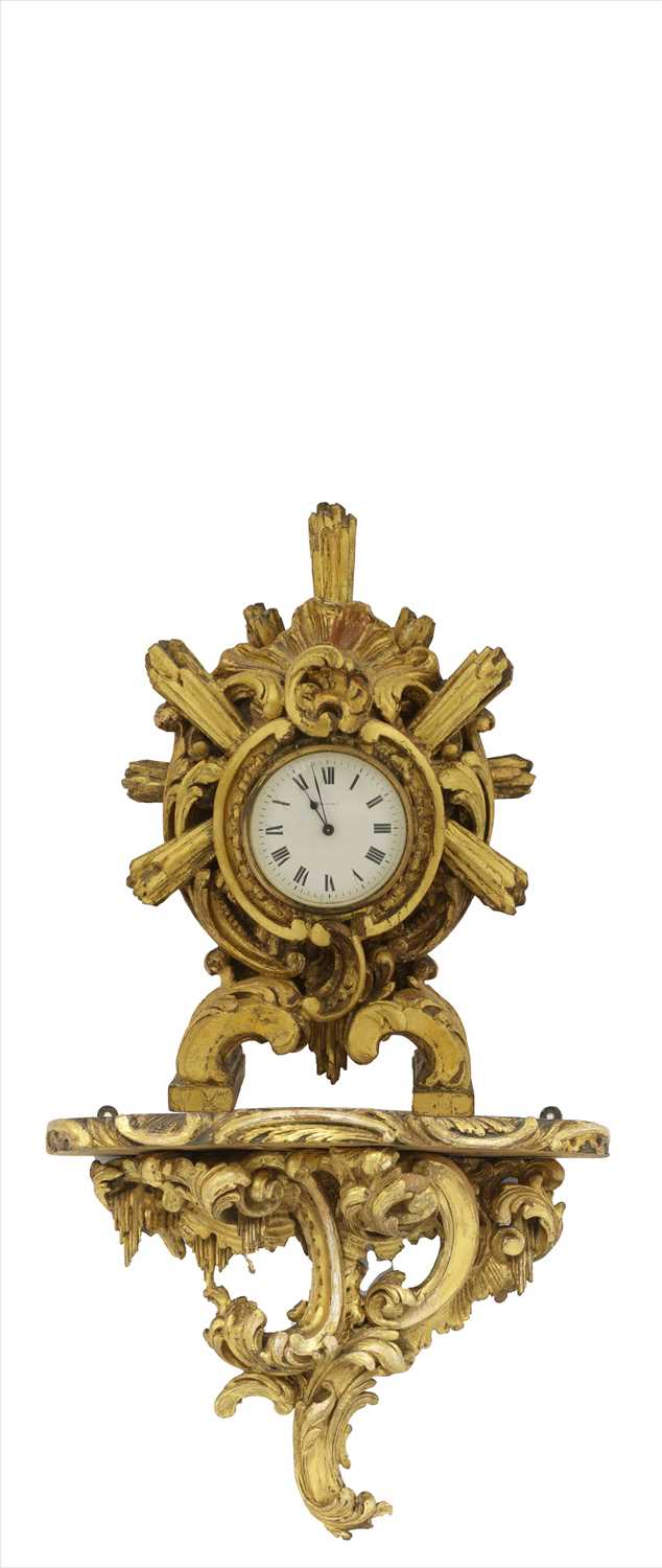 A carved giltwood cased mantel clock,