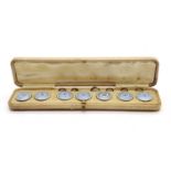 A cased set of seven blue enamel studs/buttons,
