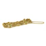 An Edwardian gold peridot and split pearl four row gate bracelet,
